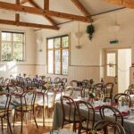 Tables set up inside East Dean Village Hall